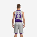 Silver reversible basketball jersey side view showing purple trim binding and contrast slash graphic across lower chest