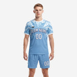 Men's light blue soccer uniform with white geometric crystal print, full front view of jersey and matching shorts