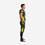 Side view of custom lime green football uniforms showing neon-green angular jersey side panels and matching outer-leg pant stripe with black diagonal accents