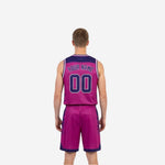 Side view of magenta-pink reverse side of reversible basketball uniform with navy-purple chevron panels and contrast trim