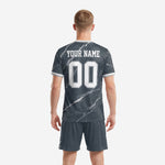 Close detail of marble print soccer jersey with white v-neck trim and collegiate lettering