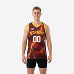 Custom maroon and gold basketball jerseys with full-coverage gold lightning bolt sublimation pattern, team name on chest and front number 00, V-neck collar with gold trim, front view on male model