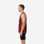 Side view of maroon custom basketball jersey with full-length gold side stripe and gold armhole binding on male model