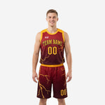 Custom maroon and gold basketball uniforms with lightning bolt sublimation print, gold shoulder panels, and matching shorts - front view