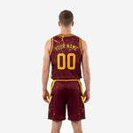Opposite side view of maroon and gold sublimated basketball uniform set showing matching shorts waistband and side panel detail