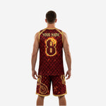 Opposite side view of maroon and gold basketball uniform set showing gold dragon artwork on shorts leg panel and elastic waistband detail