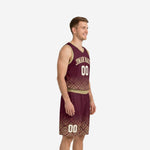 Side view of maroon and gold sublimated basketball uniform set with geometric diamond fade pattern and gold V-neck binding on adult male model