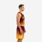 Side view of maroon and gold sublimated basketball uniform showing gradient from maroon shoulders to gold hem on jersey and shorts