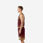Side view of maroon and gold basketball uniform set showing gold armhole binding V-neck trim and matching gold waistband on shorts