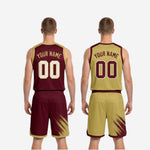 Full set view of the maroon and gold reversible basketball uniform laid flat showing both the jersey and matching shorts together