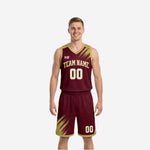 Maroon and gold reversible basketball uniforms showing both the maroon side and gold side of the two-piece set with brush-stroke panels and player numbers