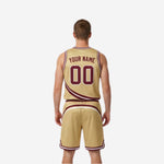 Side view of the gold reversible basketball uniform showing maroon diagonal swoosh stripe and armhole binding detail on the jersey