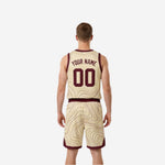 Cream-gold side of the reversible basketball uniform with maroon V-neck binding, contour-line pattern, and arched team name across the chest