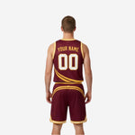 Side view of the maroon reversible basketball uniform showing bound armhole construction and diagonal gold stripe on the jersey side panel