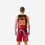 Side view of maroon and gold reversible basketball uniform showing gold armhole binding trim and lightning bolt pattern along the side panel