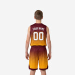 Opposite side view of custom maroon and gold youth basketball jersey and shorts showing armhole binding and gradient panel detail