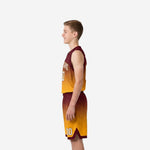 Side view of maroon and gold youth basketball uniform set showing continuous gradient fade from waistband to hem with chevron accent