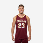 Custom maroon and yellow basketball jersey with arched team name, front number 23, gold binding trim at crew neck and armholes, white side panels - front and back view