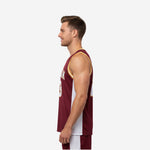 Side view of custom maroon basketball jersey showing white side panel construction and gold armhole binding trim detail