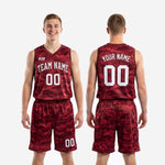 Full maroon basketball uniform set showing digital camo jersey and shorts together, sublimated in maroon and red pixelated camouflage