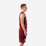 Side view of maroon digital camo basketball uniform set showing V-neck jersey body and matching shorts with white back name visible
