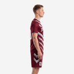 Left side view of maroon chevron soccer outfit showing sleeve and shorts panel detail