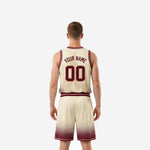 Back view of cream and maroon custom basketball uniform sets showing back number and player name placement in maroon on cream base