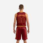 Right side view of custom basketball uniforms for men in maroon and gold displaying the gold elastic waistband, drawcord shorts, and side split at the hem