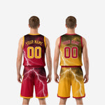 Detail shot of gold reversible basketball shorts with white lightning graphic, maroon hem trim, elastic waistband, and drawcord on the gold side