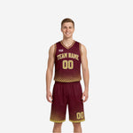 Maroon and gold reversible basketball uniforms with halftone dot fade, arched team name, and gold numbers on the front of the jersey and matching shorts