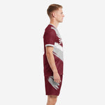 Maroon and grey soccer uniform side view showing brush stroke pattern wrapping across jersey and shorts