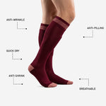Adult male wearing custom maroon soccer socks with rose-pink contrast cuff, full calf length visible