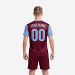 Sublimated maroon soccer jersey with sky blue sleeves and v-neckline detail