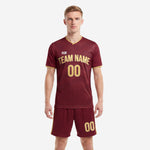 Front view of custom maroon soccer uniforms with Vegas Gold geometric print, V-neck jersey and matching shorts on male model