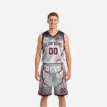 Front view of custom maroon reversible basketball uniform with white lightning pattern and arced team name across the chest
