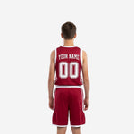 Close-up side panel detail of maroon youth basketball uniform showing bold angled white stripes running down the shorts leg and jersey side insert