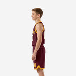 Front view of custom maroon and gold youth basketball uniform with arched team name across chest and white outlined number 00