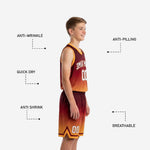 Close detail of maroon and orange youth basketball shorts showing honeycomb hex texture elastic waistband drawcord gold hem binding and chevron accent