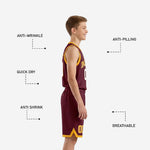 Left side view of custom maroon youth basketball uniform showing gold V-neck binding, armhole trim, and matching maroon shorts