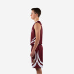 Side view of maroon youth basketball uniform set showing white binding at armhole and curved white shorts graphics from hem to mid-leg