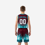 Opposite side view of maroon youth basketball uniform set displaying the teal V-notch hem detail on the shorts