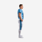 Side view of matching team football uniforms showing the Columbia blue and navy three-stripe pant side panel and short-sleeve sublimated jersey