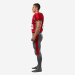 Opposite side view of mens custom football uniform in red and gray showing sleeve binding trim and full-length red pant stripe
