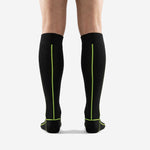 Black and green soccer socks calf panel detail with neon green contrast stitching running from cuff to arch zone