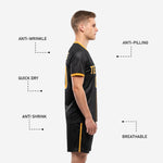 Close-up detail of men's black and gold soccer jersey showing tone-on-tone chevron pattern and sublimated gold lettering
