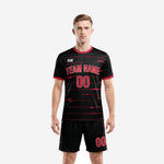 Mens black and red soccer uniforms front view showing crimson stripe pattern on jet black jersey and matching shorts