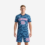 Mens camo custom soccer uniform kit in steel blue and hot pink, front view showing arched team name and front number on full two-piece set