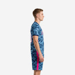 Mens camo soccer uniform kit side view showing hot pink side panel stripe on steel blue camo jersey and matching shorts
