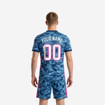 Close detail of steel blue camo sublimated soccer jersey with hot pink trim and custom team name print zone on chest