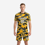 Mens yellow soccer uniform in Athletic Gold and Jet Black geometric camo print, full 2-piece kit front view